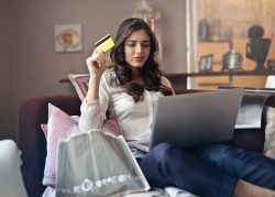 woman-holding-card-while-operating-silver-laptop-919436-1536×1102