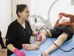  Vein doctor examines the spider and varicose veins